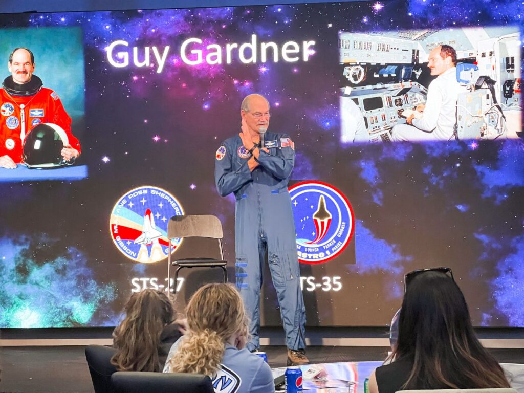 Retired astronaut on stage at Chat with an Astronaut at Kennedy Space Center 