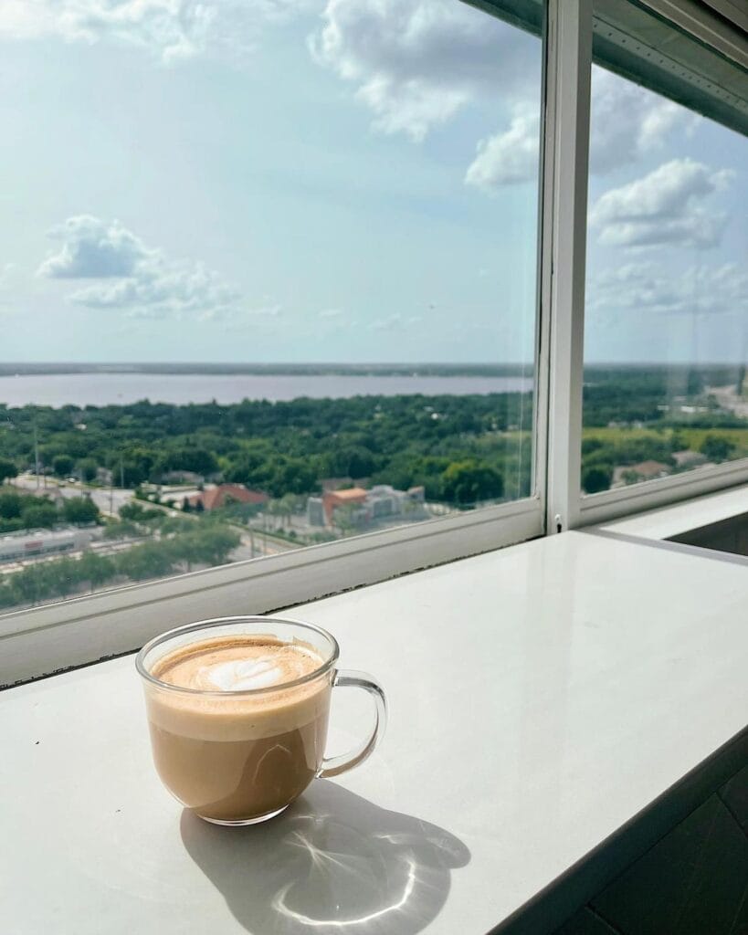 Coffee perched on viewing window of Florida Citrus Tower - @floridacitrustower