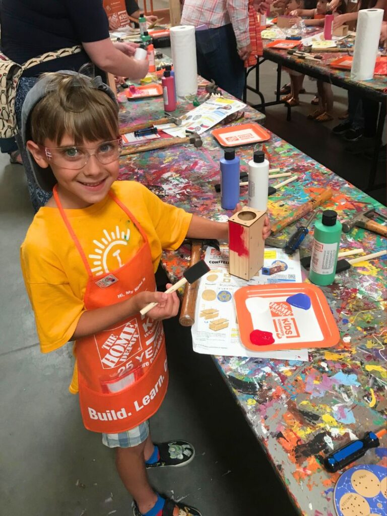 a young boy participates in Home Depot Workshops