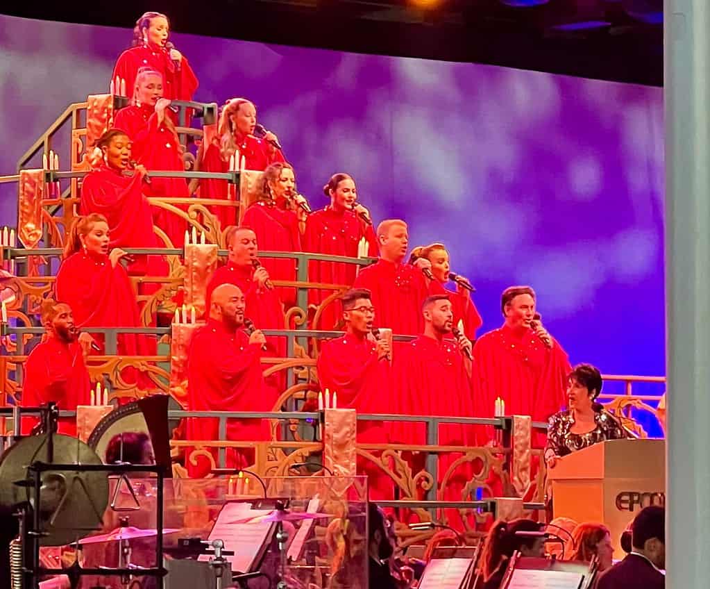 A choir sings during Candlelight Processional During Christmas at Disney World
