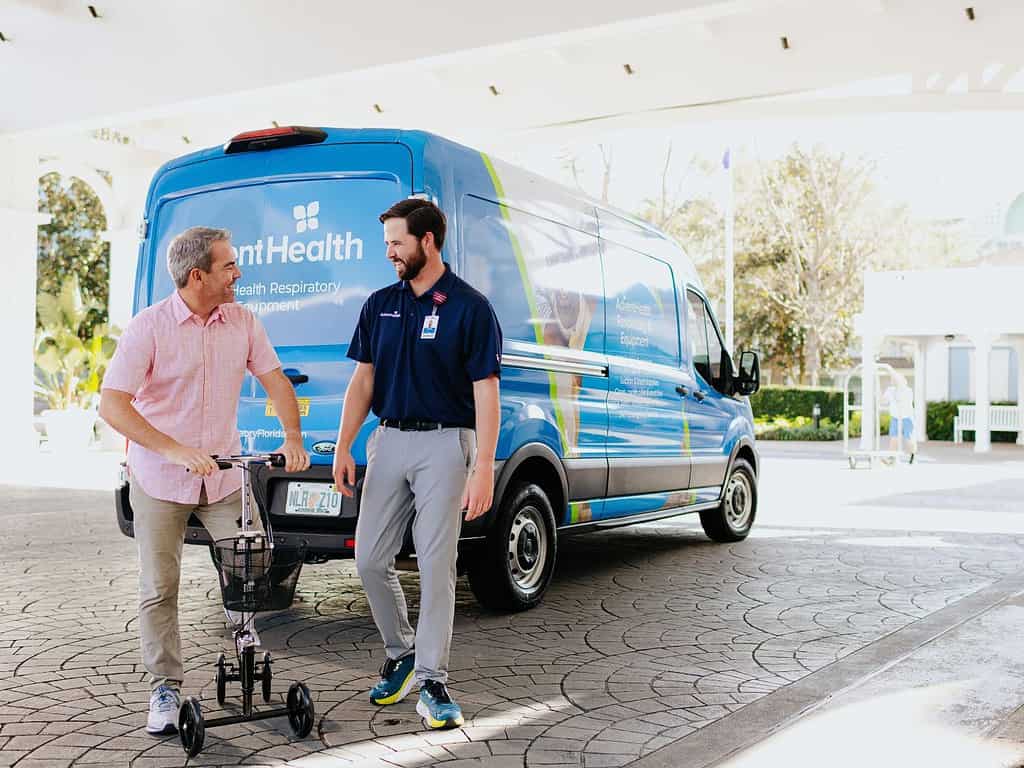 an AdventHealth employee helps a Walt Disney World guest with medical equipment delivery to a Walt Disney World hotel