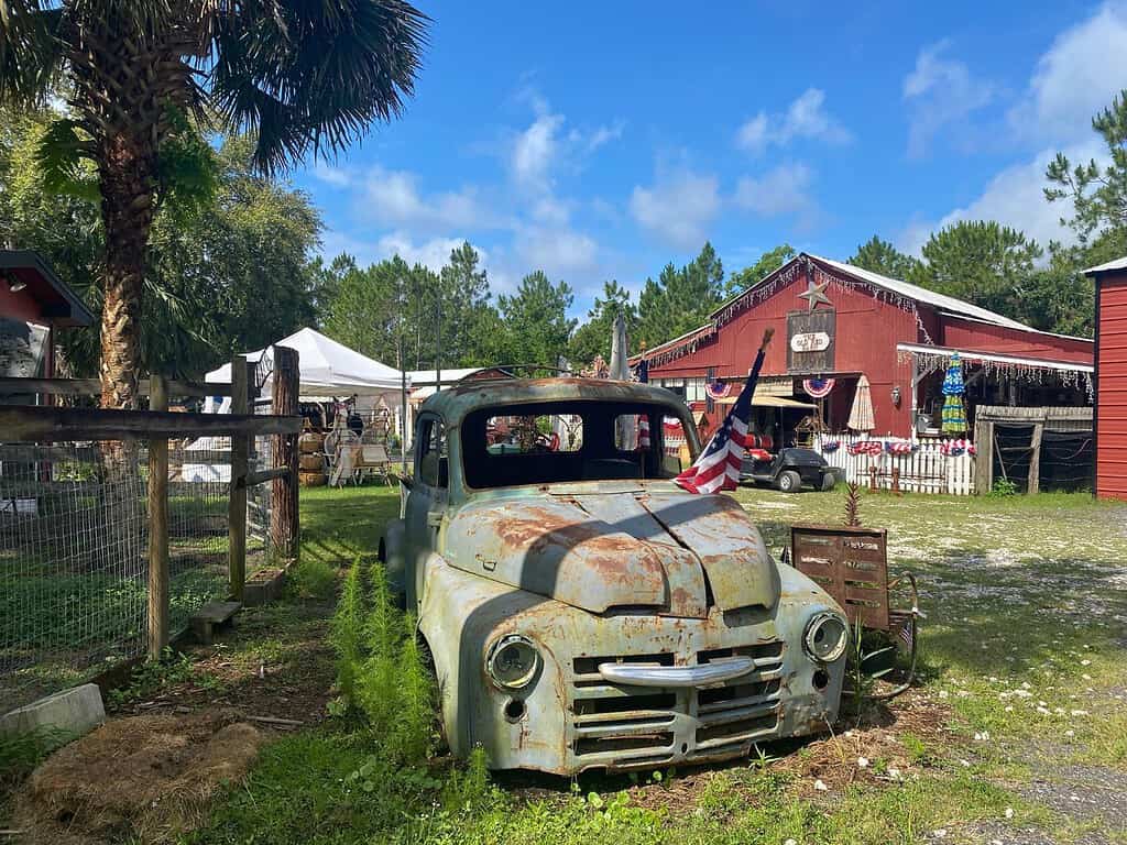 Old Red Barn Antique Pick-Up Truck Parked Out Front 