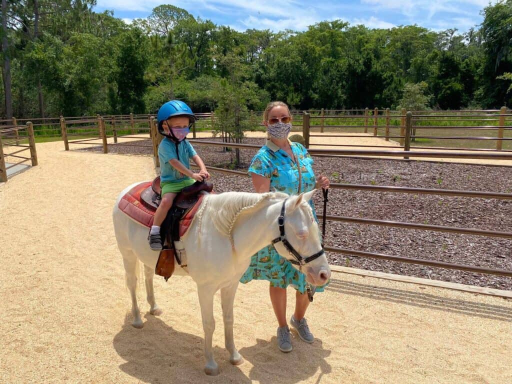 a mom and her son experience Disney Pony Rides at Tri Circle D Ranch Fort Wilderness 