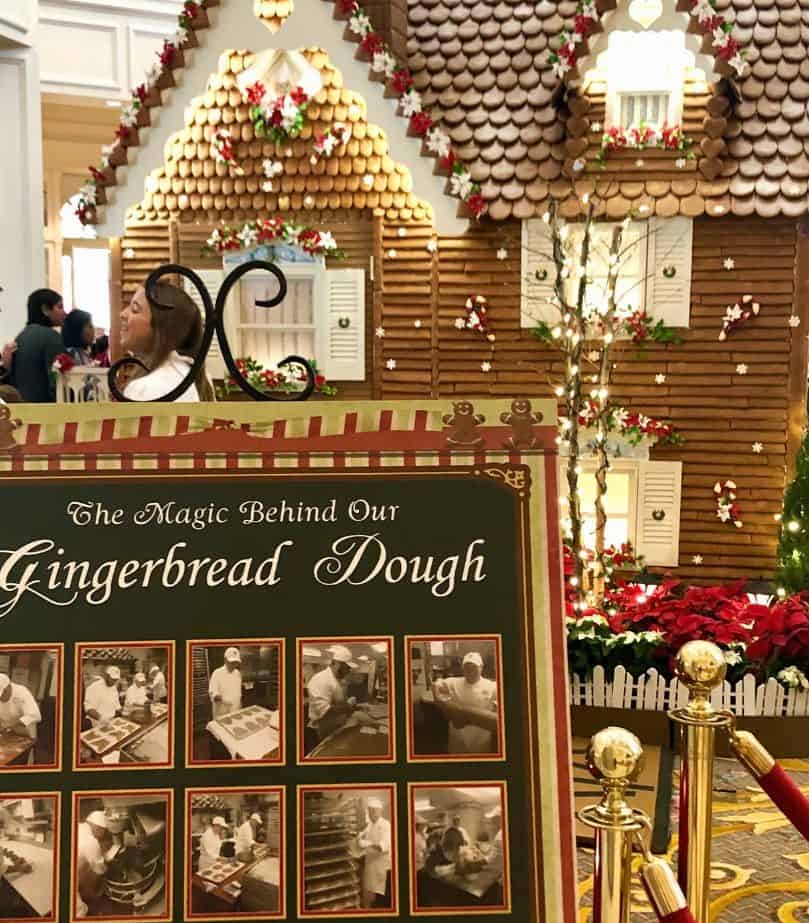 sign with photos of cast members working on the Gingerbread House Display at Disney's Grand Floridian