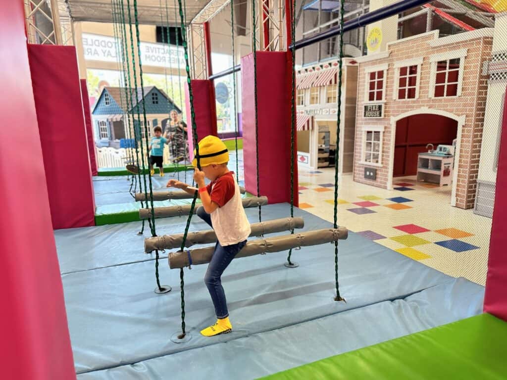 a child climbs ropes at Kidiverse Indoor Play Area Orlando 