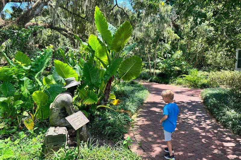 a child looks at plants and identification signs Leu Gardens Orlando