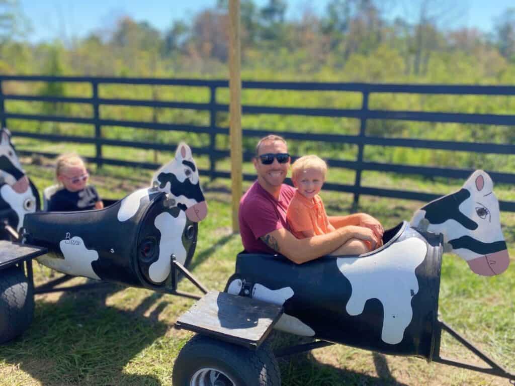 Two people on cow train ride at Amber Brooke Farms