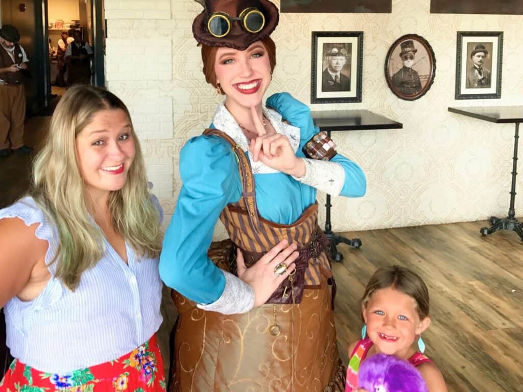 a mother and daughter pose with a character greeting at Toothsome Chocolate Emporium Universal CityWalk