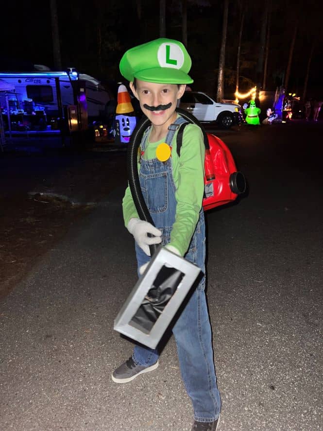 young boy dresses as Luigi from Super Mario Brothers at Disney's Fort Wilderness Campground