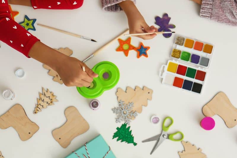 stock image of christmas crafts being worked on by kids