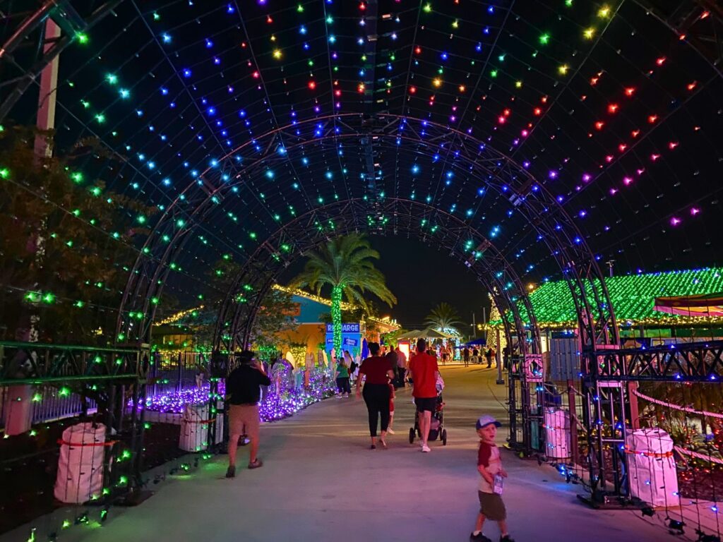 guests walk through archway of christmas lights at Holiday Nights at Island H2O Water Park 