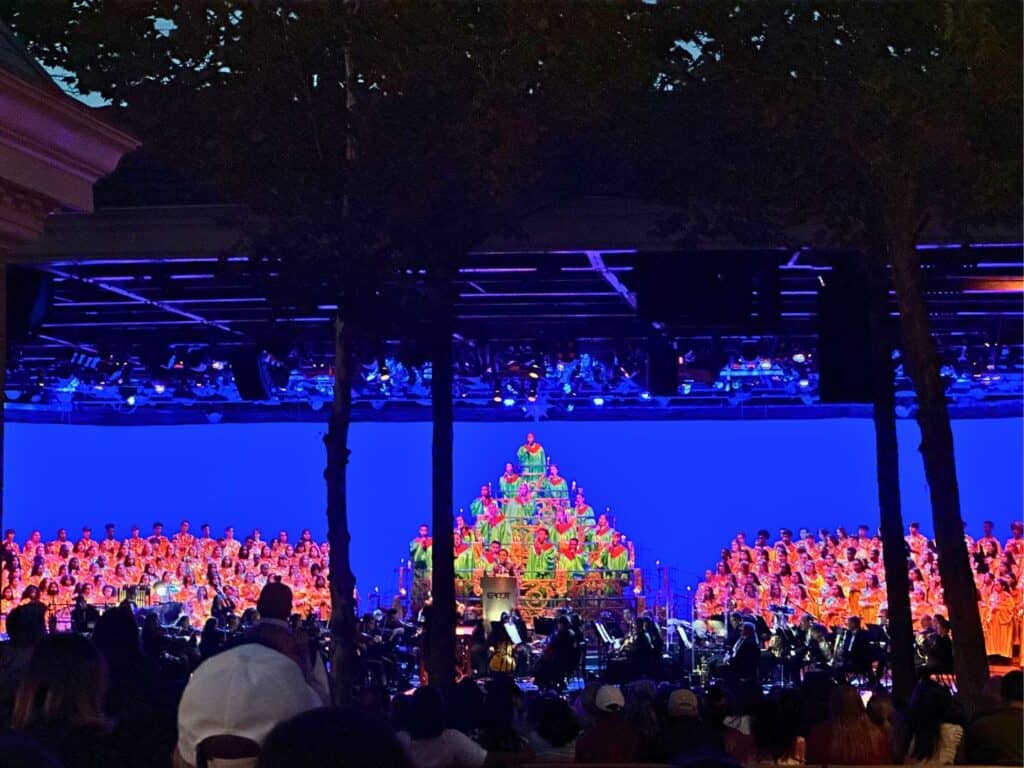 John Stamos Celebrity Narrator Candlelight Processional on stage at the  EPCOT International Festival of the Holidays presented by AdventHealth 