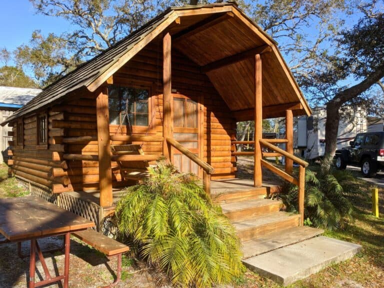 Image of the outside of a St. Augustine’s KOA Cabin with picnic table