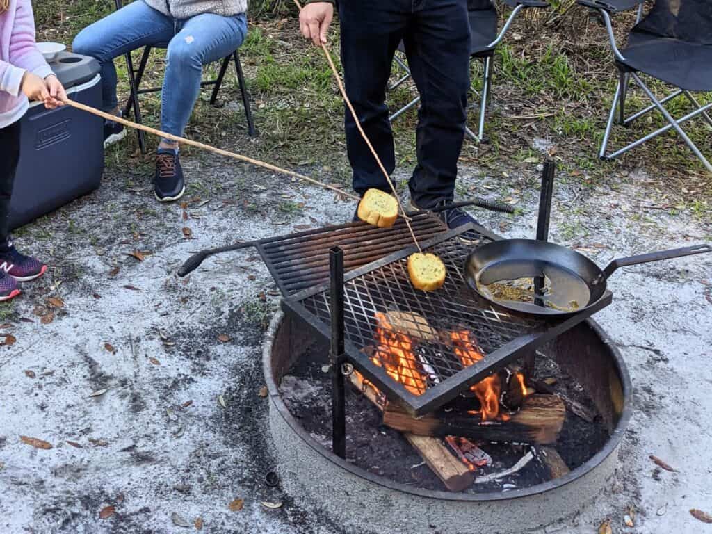 Image of people cooking over a fire pit at Blue Springs