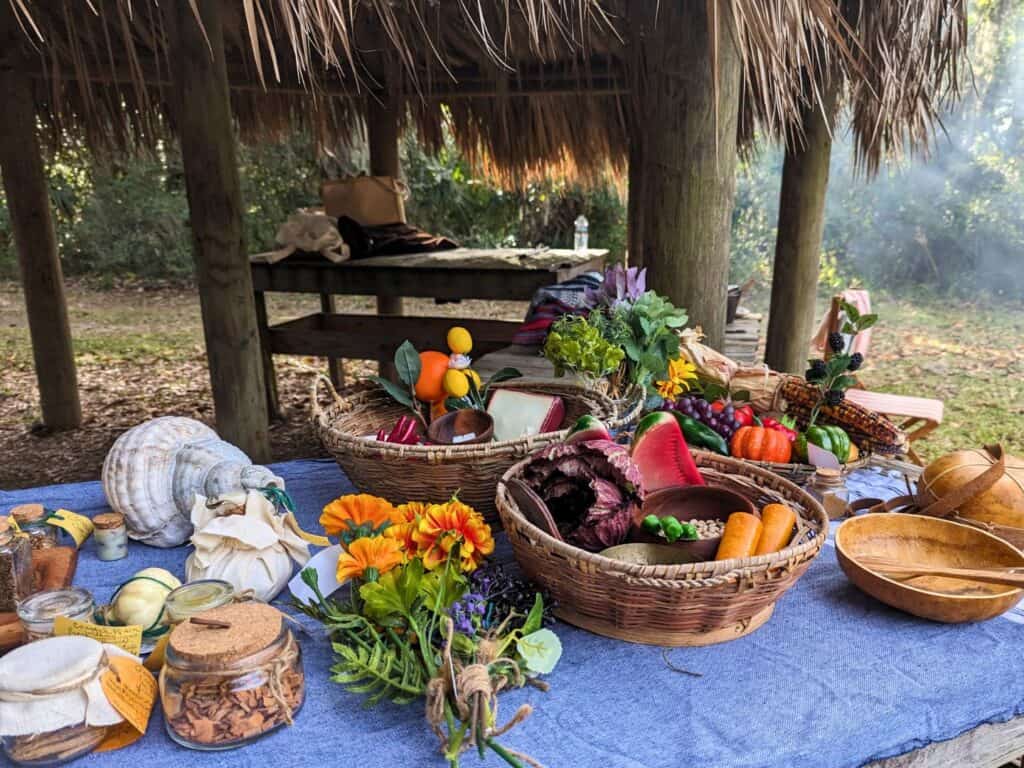 Image of an outdoor table with food and flowers at Fort Mose Historic State Park
