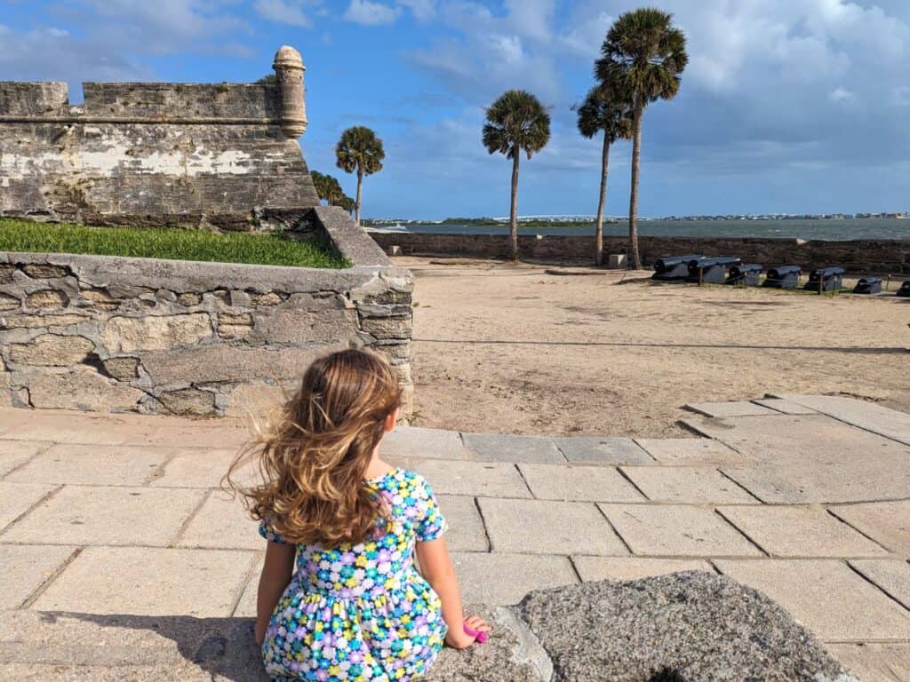 Image of child looking at fort and cannons at Castillo de San Marcos National Monument