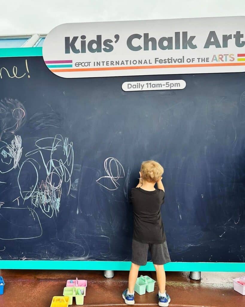 Young Boy Participating at Kids' Chalk Art EPCOT Festival of the Arts 2024 - 