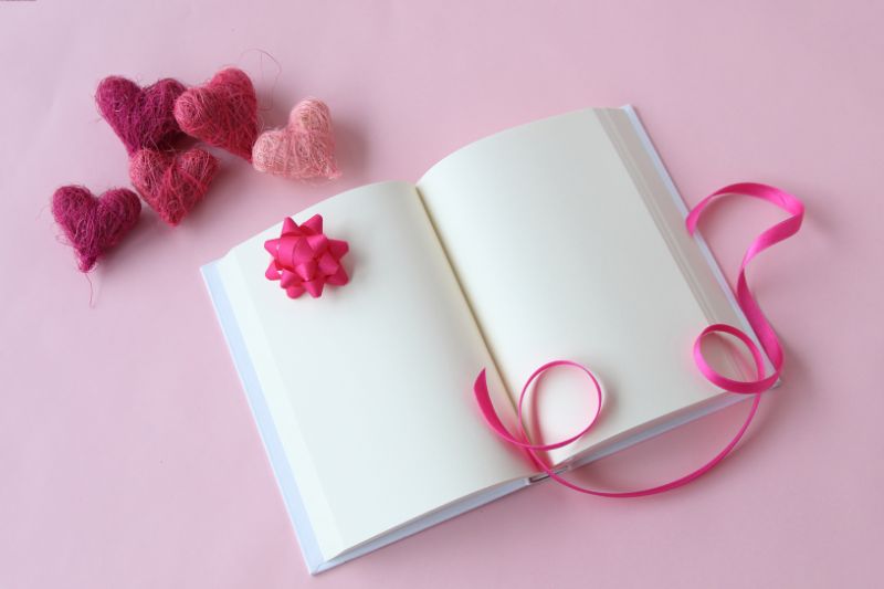 Valentine's Day Activities and Crafts for Kids Orlando pink book and ribbon - stock image Hana-Photo from Getty Images