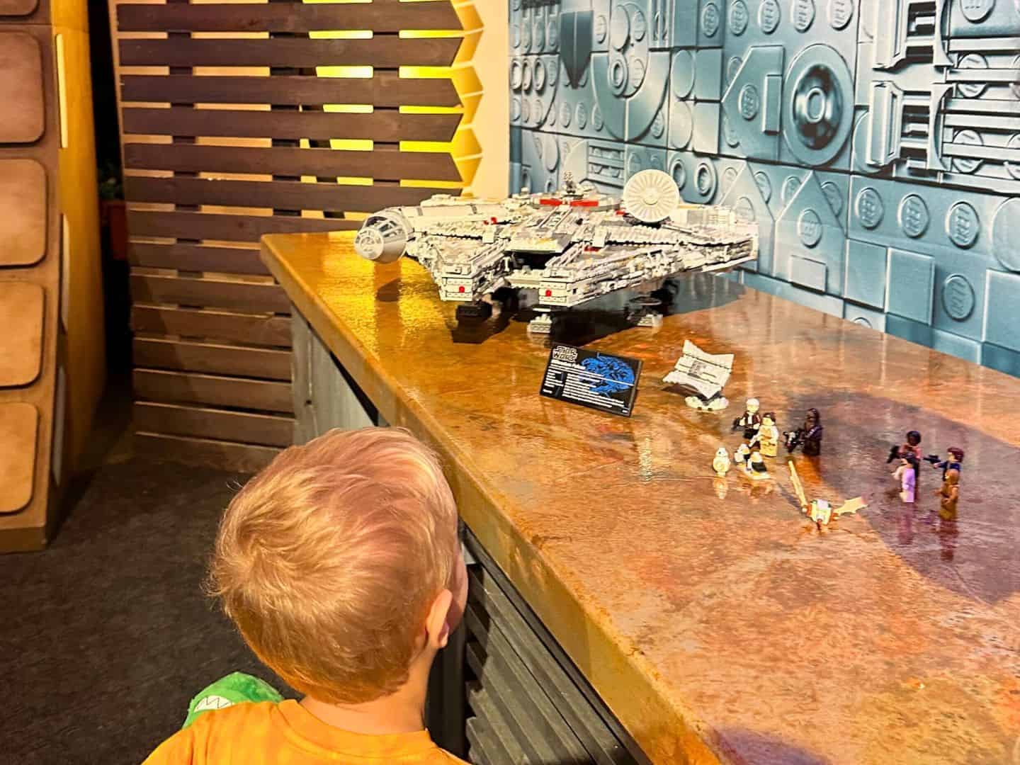 Young Boy Looks at Millennium Falcon LEGO Set 25th Anniversary - image by Dani Meyering