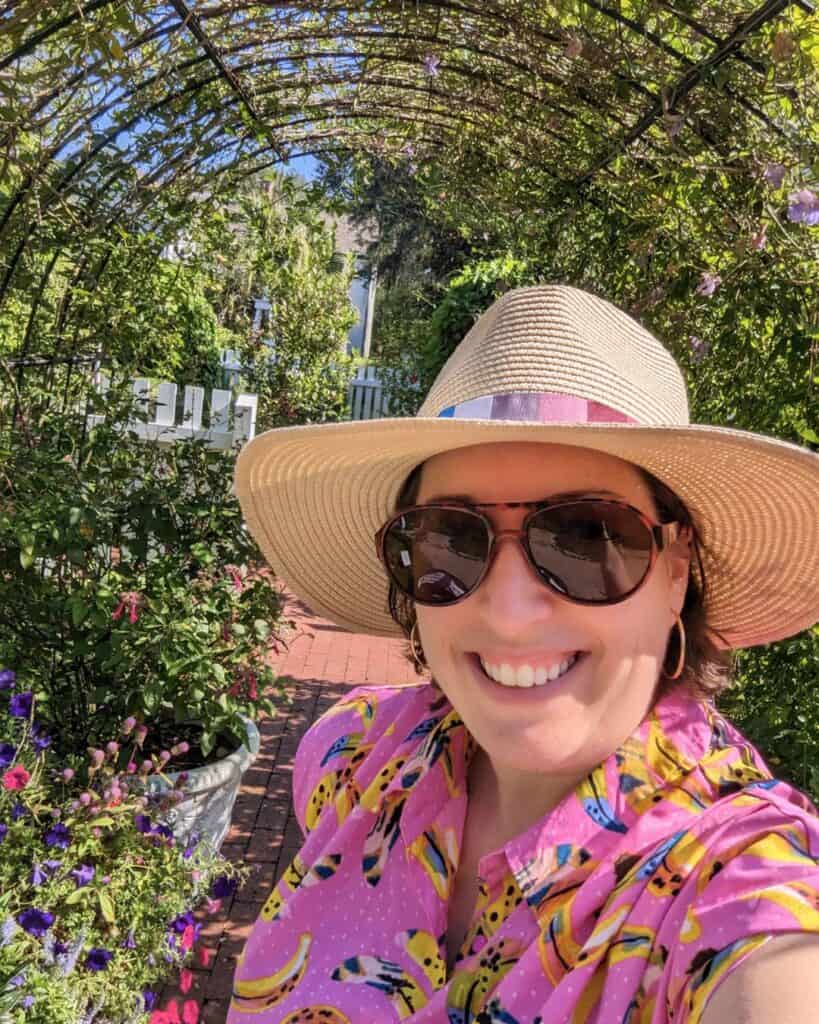 Image of a smiling woman in a hat at Leu Gardens
