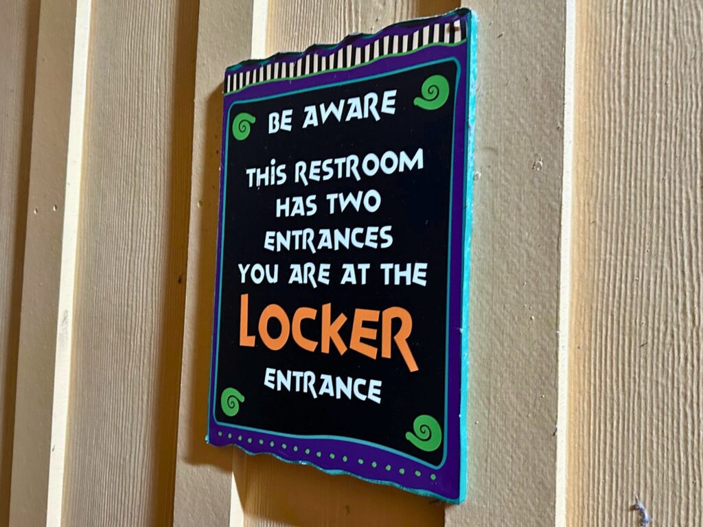 sign at Aquatica Orlando restroom that reads This Restroom Has Two Entrances You Are at the Locker Entrance