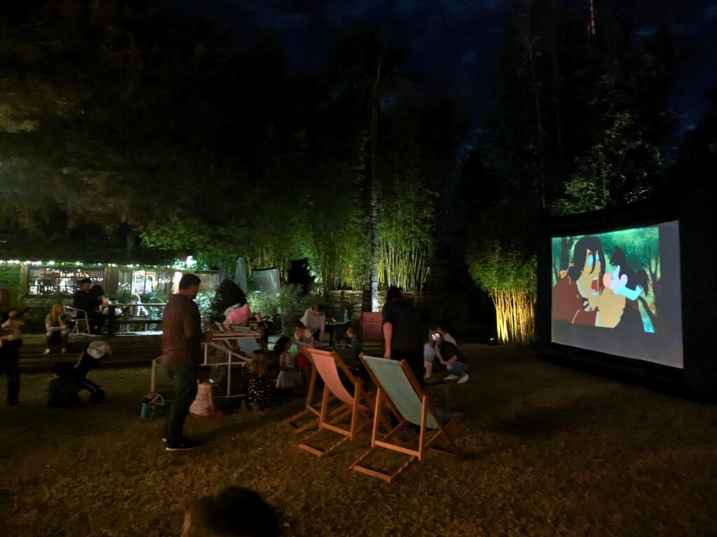 Image of people watching a family movie at The Acre Orlando