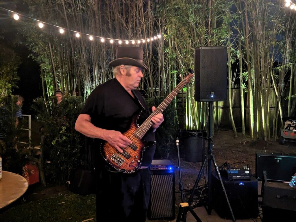 Image of a man playing guitar at The Acre Orlando