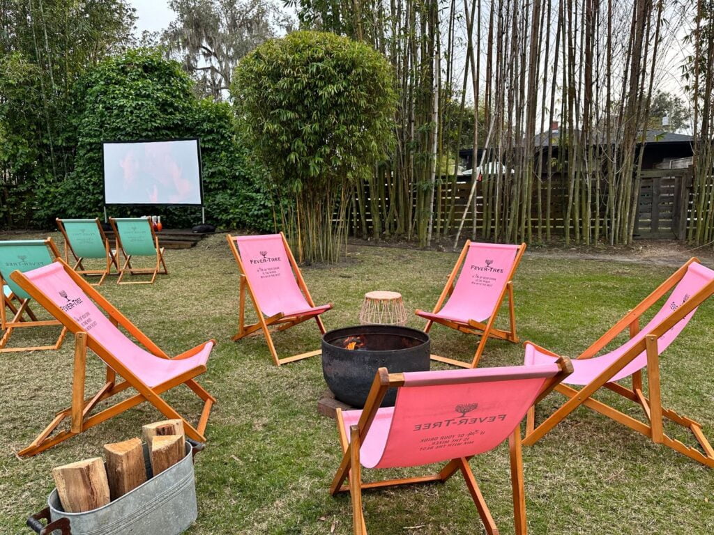 folding chairs around The Acre firepit and movie screen 