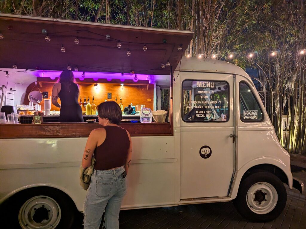 Image of a woman ordering a drink from the tequila bar truck at The Acre Orlando