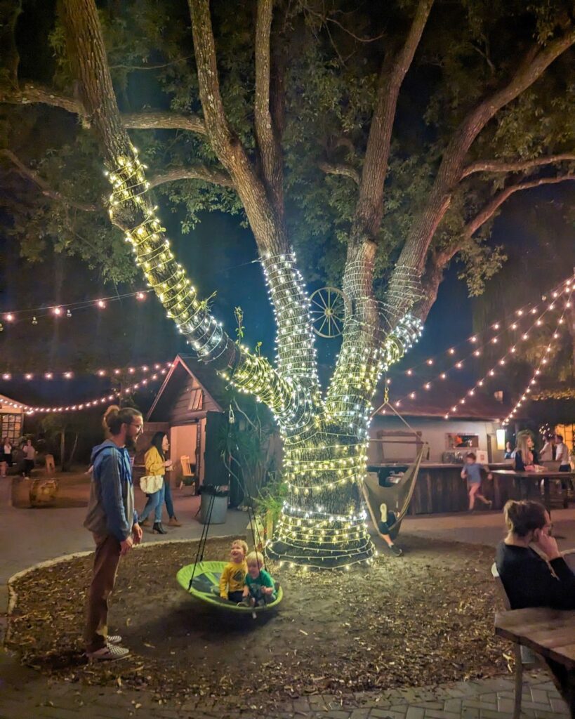Image of kids on a swing at night at The Acre Orlando