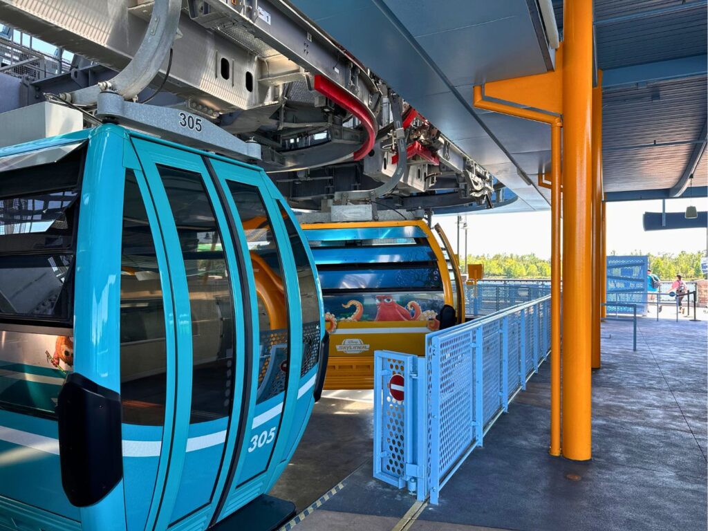 two gondolas wait at Disney Skyliner Station at Disney's Art of Animation Resort -