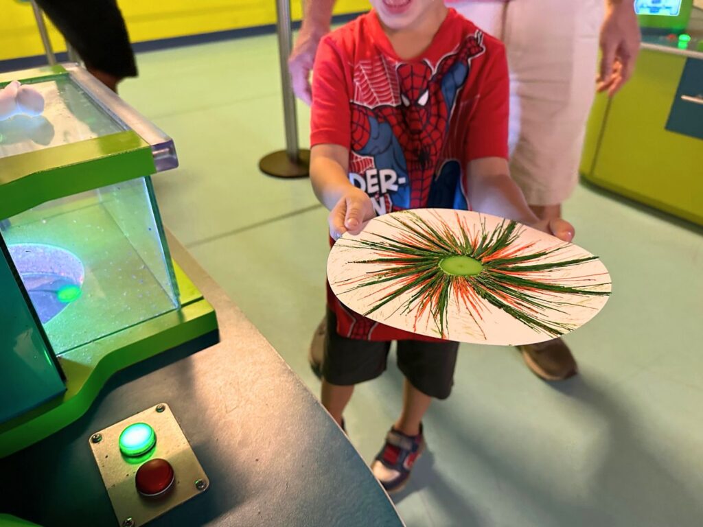 Young Boy Showing His Drip Art at Crayola Experience Orlando
