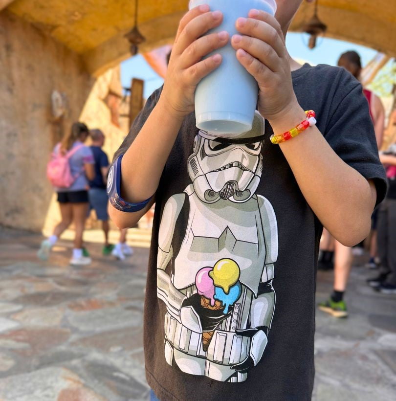 Young Boy Wearing a Stormtrooper Shirt Drinking Blue Milk at Star Wars Galaxy's Edge Walt Disney World 