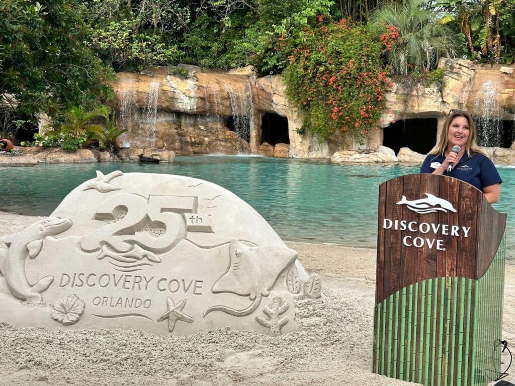 Crystal O'Hea President of Marketing at Discovery Cove speaking during 25th anniversary celebration - image by Dani Meyering