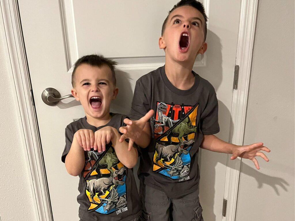Two boys wearing Jurassic Park Live t-shirts