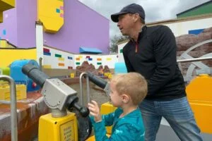 Father and son aboard Battle of Bricksburg Water Ride at LEGOLAND Florida - image by Dani Meyering