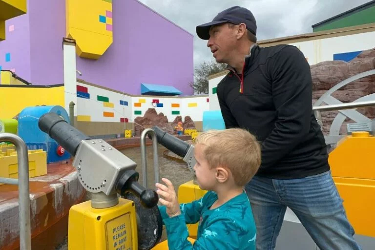 Father and son aboard Battle of Bricksburg Water Ride at LEGOLAND Florida - image by Dani Meyering