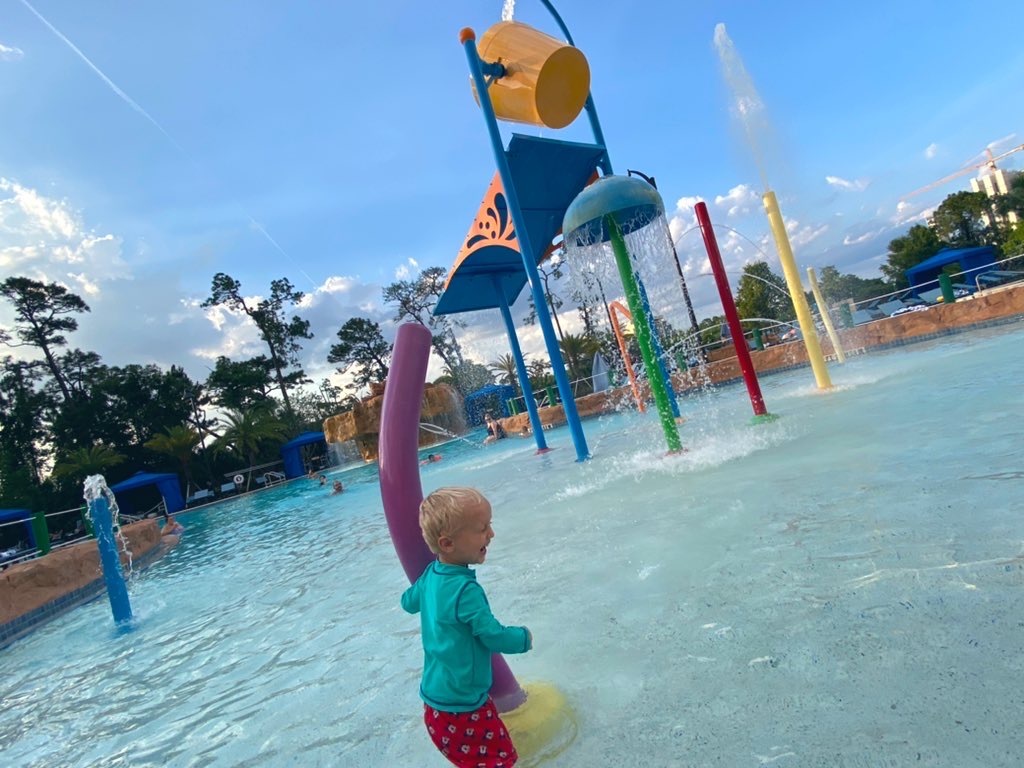 young boy at water play area at wyndham garden disney springs lake buena vista