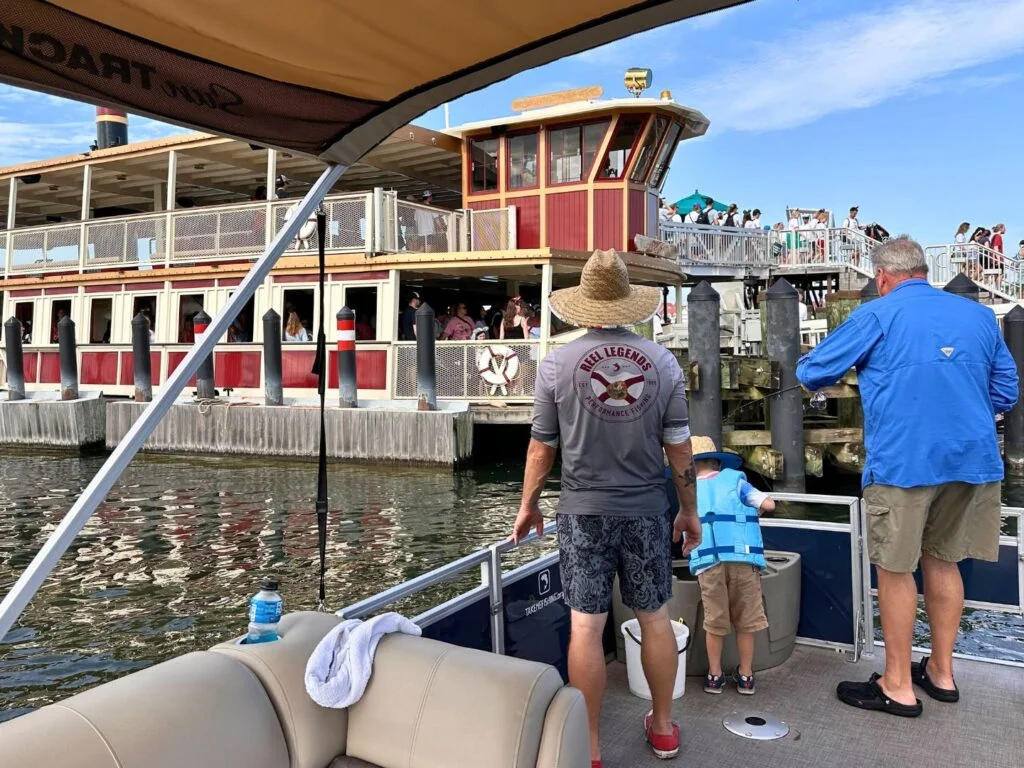 Father and son with fishing guide attempt to catch fish near Magic Kingdom ferry boat