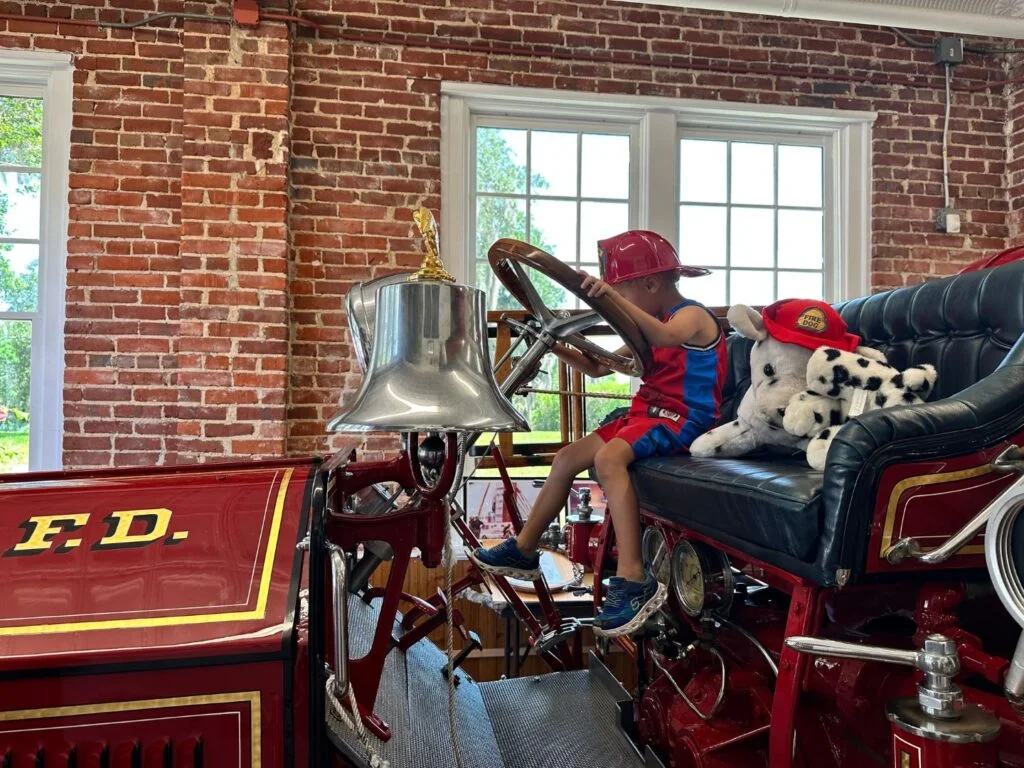 Young boy inside fire truck at Orlando Fire Museum