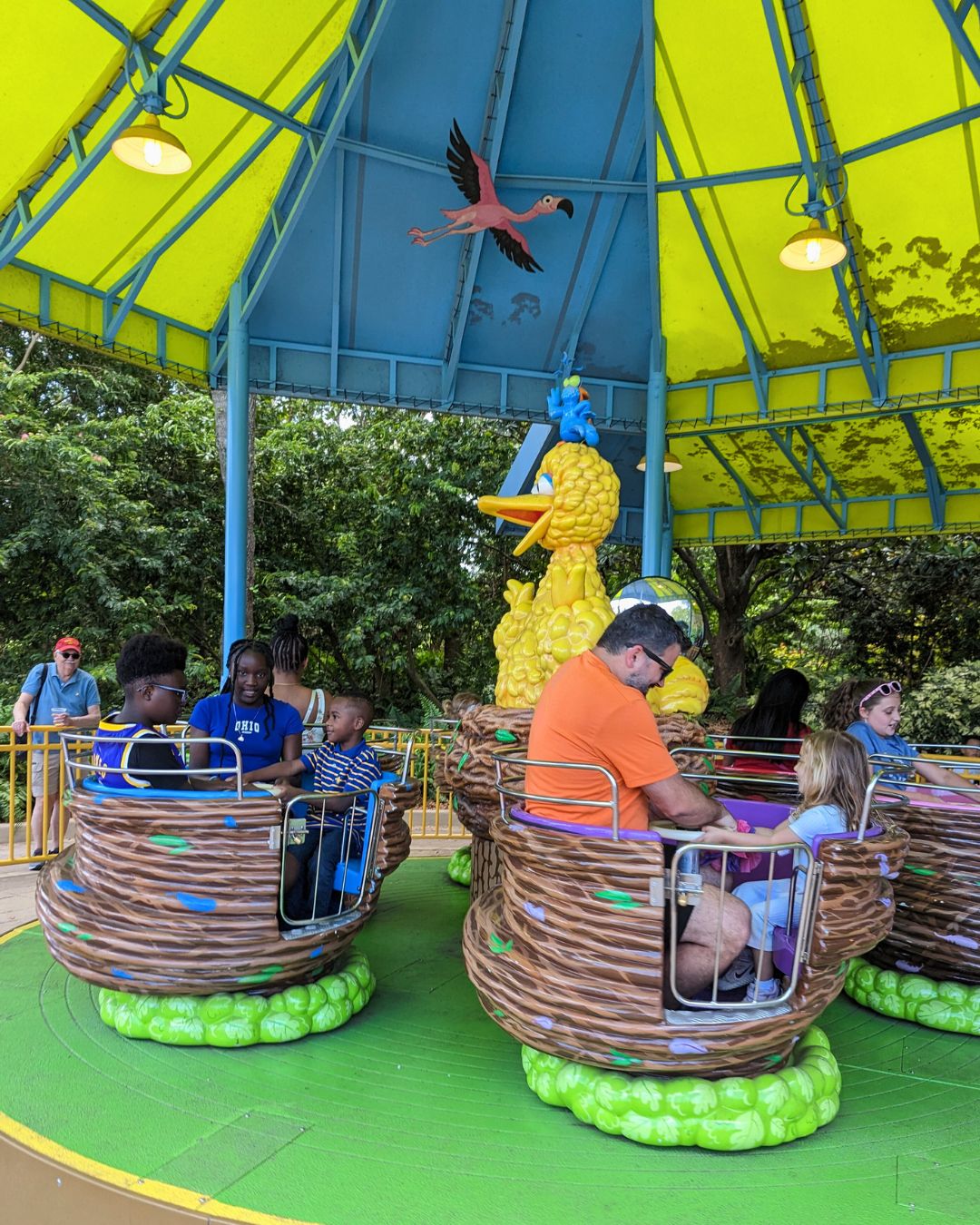 Adults and children riding a kids ride at Sesame Street at SeaWorld Orlando