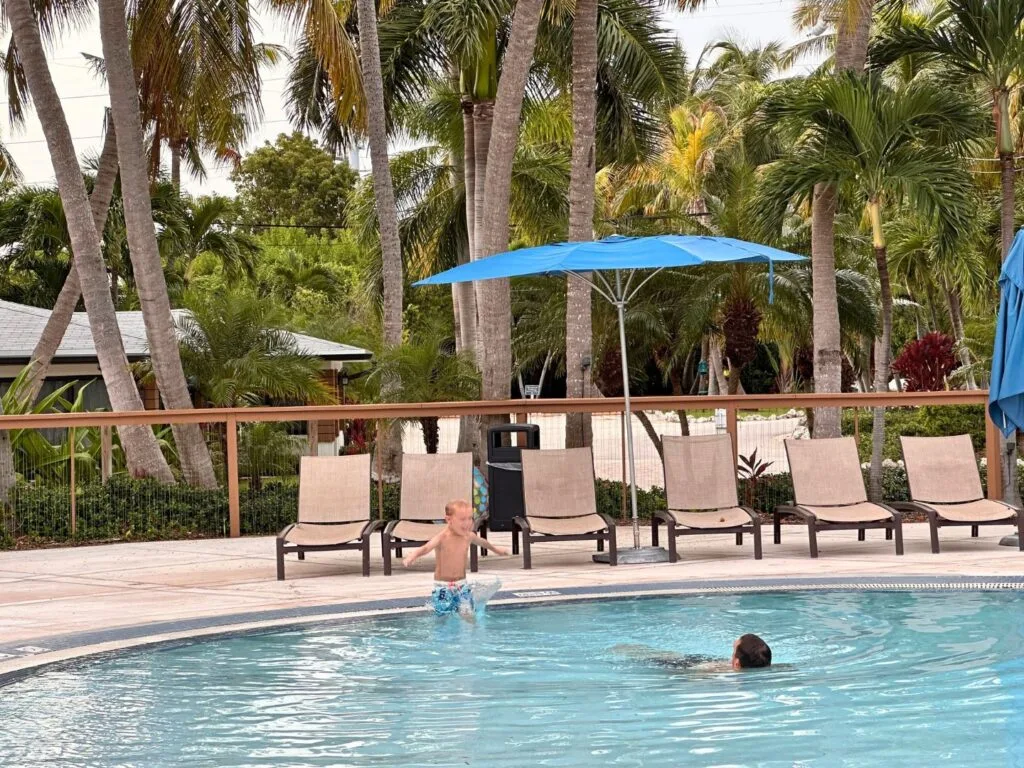 Boy and Dad Play in La Siesta Resort & Villas Beachfront Pool