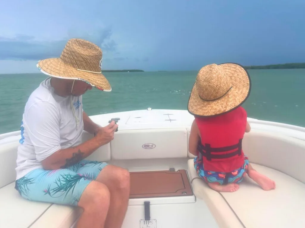 Father and son at front of boat on Wild Dolphin Tours Islamorada Florida Keys