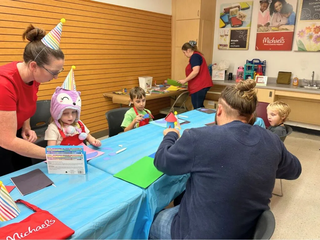 Kids working on craft projects at Michaels Store birthday party