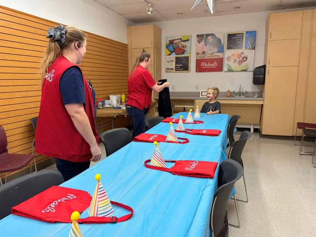 Young boy receives personalize apron provided by Michaels Birthday Parties