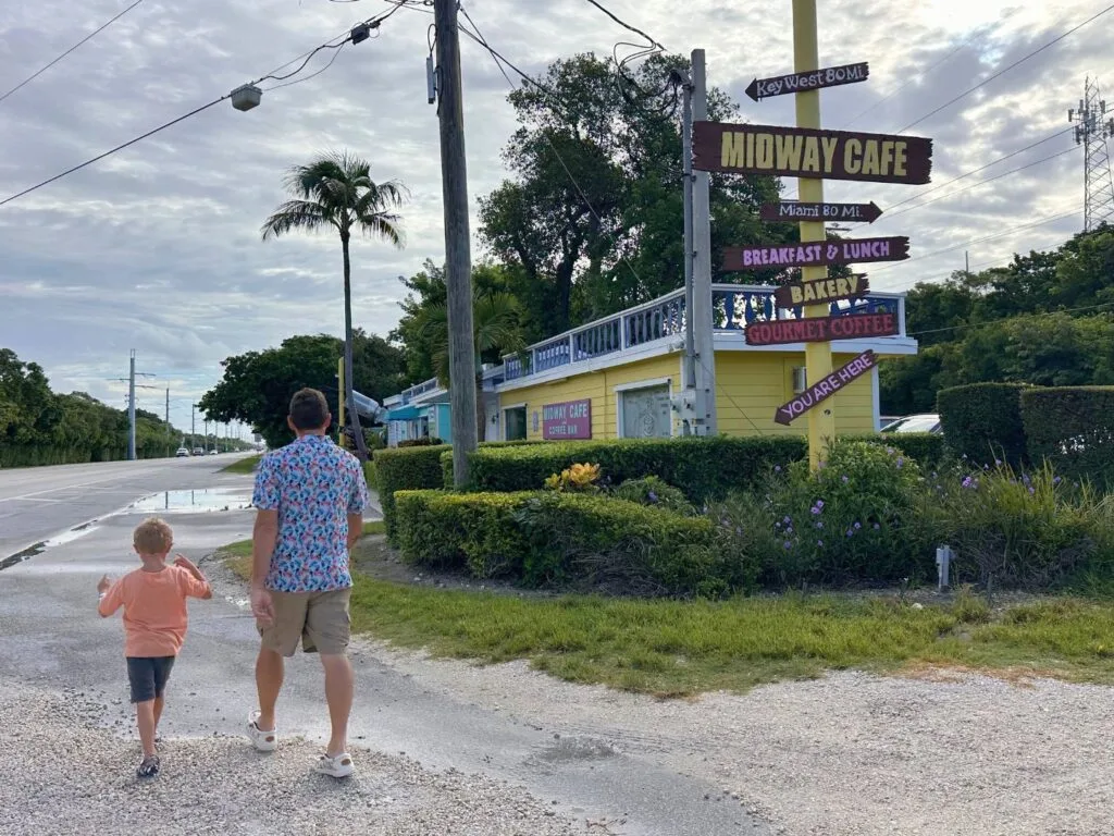 father and son walk to Midway Cafe cute coffee shop in Islamorada next to La Siesta Resort