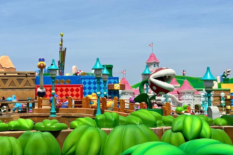 Yoshi's Adventure portion of ride path looking towards Princess Peach Castle in background Super Nintendo World Epic Universe - image by Dani Meyering