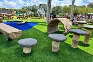 EPCOT Food and Wine Festival 2025 Harvest Hollow Play Area themed log bench and stepping stools - image by Dani Meyering