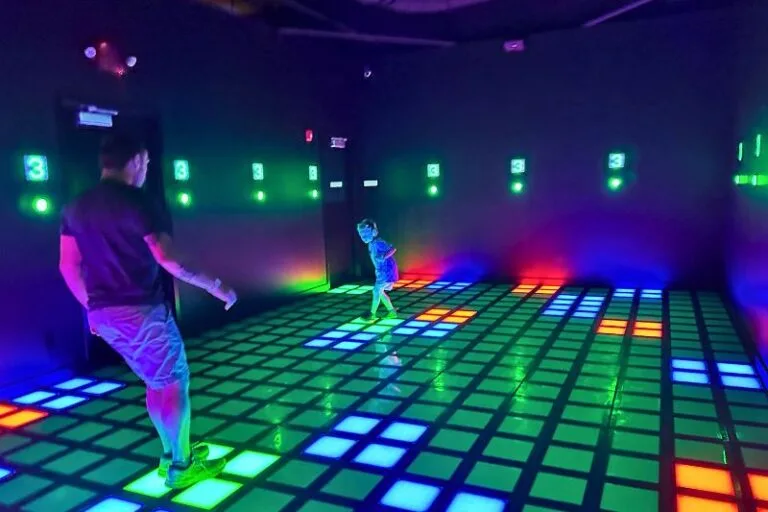 father and son inside The Grid Room at Activate Pointe Orlando multiple color squares - image by Dani Meyering