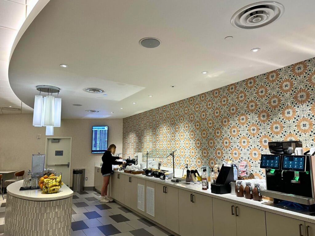 Club MCO Lounge lunch time food offerings and coffee machine - image by Dani Meyering